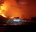 Vehicle drives through intense wildfire in California