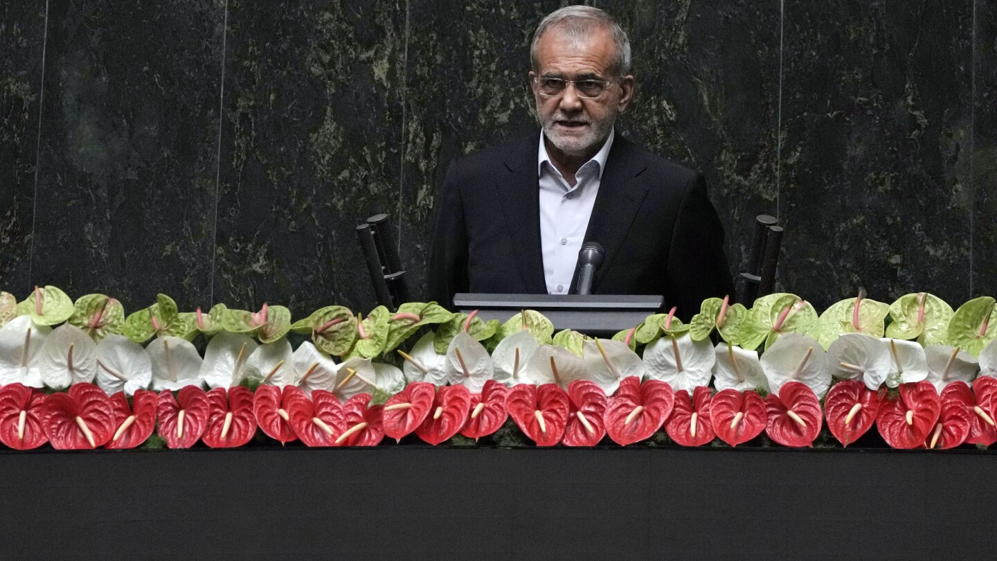 Iran’s new president is sworn in and pledges to keep trying to remove Western sanctions