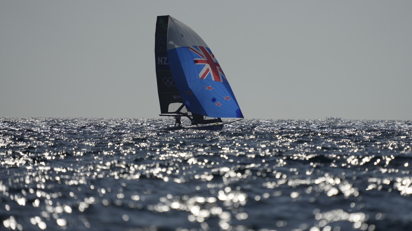 A lack of wind forces scuttles first Olympic sailing medal races, leaving sailors broiling