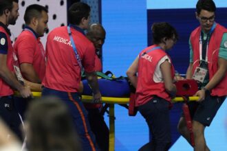 Swimmer Tamara Potocka collapses after a women’s 200-meter individual medley race at the Olympics