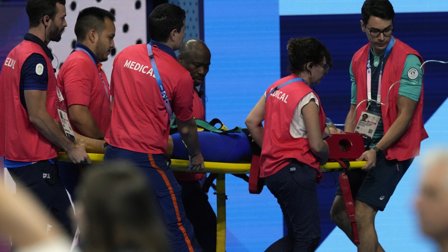 Swimmer Tamara Potocka collapses after a women’s 200-meter individual medley race at the Olympics