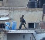 Israel investigates after its soldiers filmed throwing bodies off roof