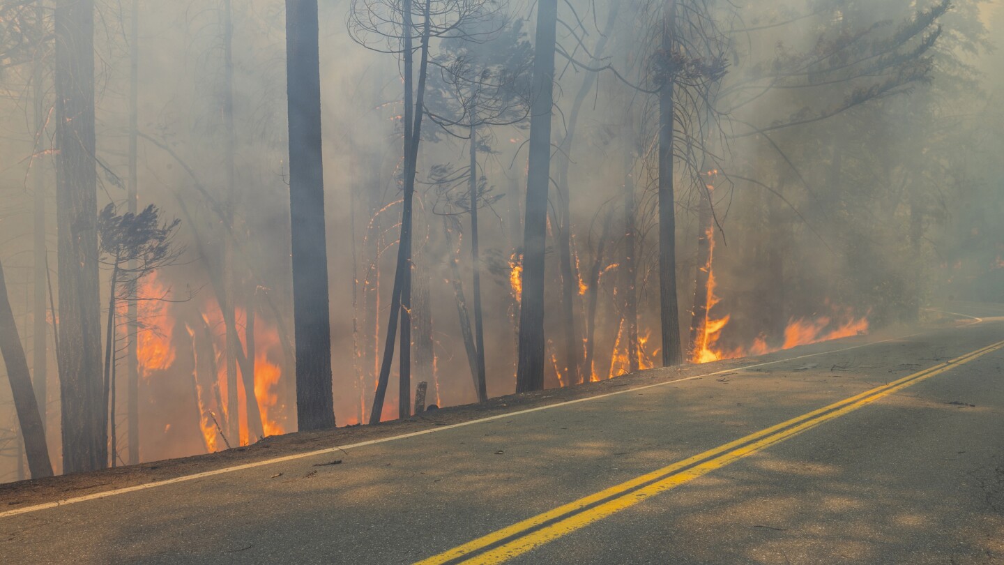 Crews battle wildfires across the US West and fight to hold containment lines