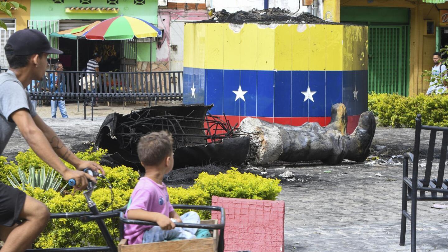 Protesters topple statues of Hugo Chavez in Venezuela as anger at election result grows