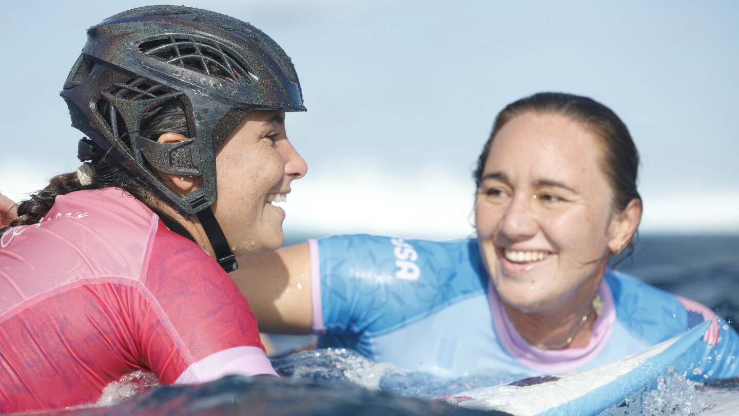 Defending women’s champion loses as Olympic surfing competition resumes with tricky Tahiti swells