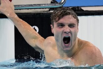 American Bobby Finke sets 1,500 freestyle world record on final night of Olympic swimming