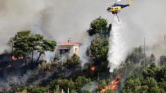 Greece wildfire forces residents to flee as heatwave persists