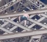 Man seen climbing Eiffel Tower above Olympics rings