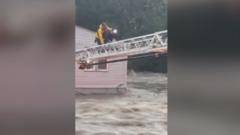 Firefighter crawls across ladder above floods to save woman