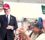 Watch: Moment Biden puts on red Trump 2024 hat