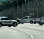 Police cars block traffic near Trump golf course