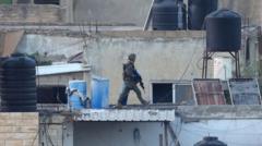 Israel investigates after its soldiers filmed throwing bodies off roof