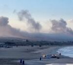 Smoke from several Israeli strikes seen from Lebanon beach